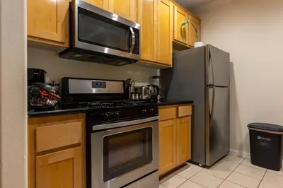 a kitchen with a stainless steel refrigerator and a microwave at Urban Haven at Orsini in Los Angeles