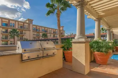 a resort with a grill on a balcony with a building at Urban Haven at Orsini in Los Angeles