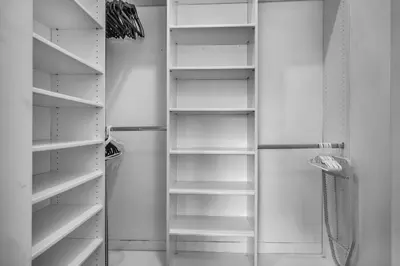 a white closet with empty shelves in it at Gramercy Getaway in Los Angeles