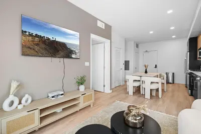 a living room with a couch and a table at Luxury & Modern Apt by the Grove in Los Angeles