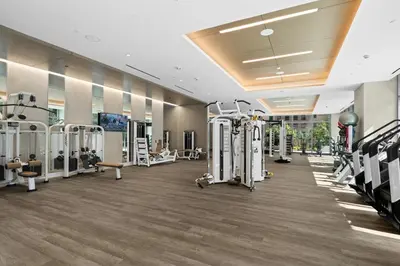 a fitness room with treadmills and machines at Brand New Modern & Luxury Residence in DTLA in Los Angeles