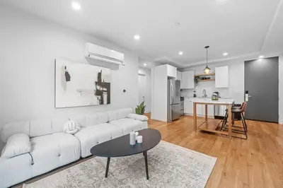a white living room with a white couch and a table at Versatile Luxury Oasis in Los Angeles