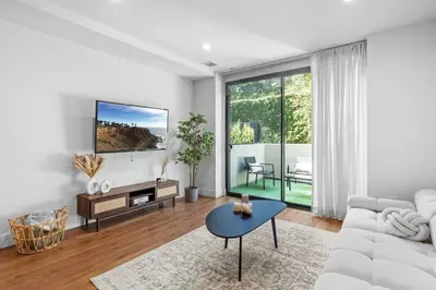 a living room with a white couch and a table at Versatile Luxury Oasis in Los Angeles