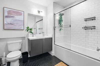 a bathroom with a toilet and a tub and a sink at Versatile Luxury Oasis in Los Angeles