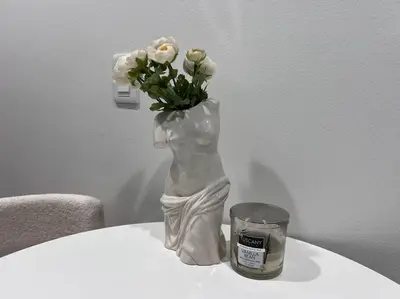 a vase of white flowers sitting on top of a table at Fortuna-Seaside Retreat in Santa Monica, steps to the beach, free parking in Los Angeles
