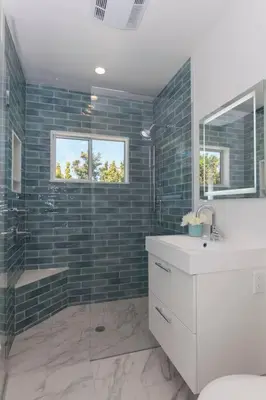 a bathroom with a shower and a sink and a mirror at Elegant Ocean View Studio in Prime Santa Monica Location in Los Angeles