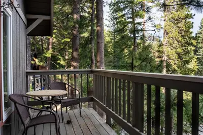 a porch with two chairs and a table on it at The Mighty Pines Retreat + Large Patio + BBQ+View! in Lake Arrowhead