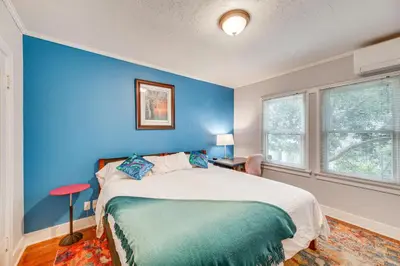 a blue bedroom with a bed and a blue wall at 2 Blocks to Melrose Ave! Home with Furnished Patio in Los Angeles
