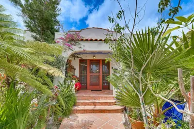 a home with a red door and some plants at 2 Blocks to Melrose Ave! Home with Furnished Patio in Los Angeles