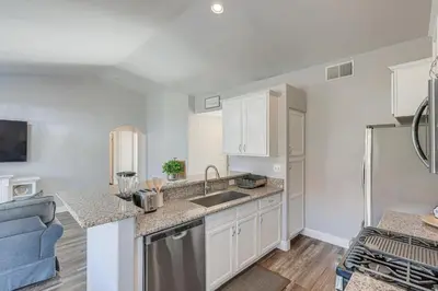a kitchen with a sink and a counter top at Bakersfield Home with Pool Table, Cornhole and More! in Bakersfield