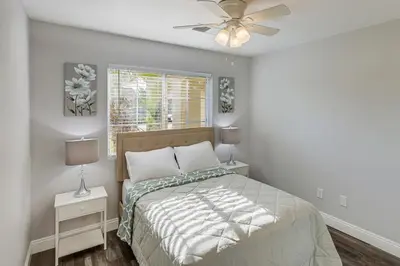 a bedroom with a bed and a ceiling fan at Bakersfield Home with Pool Table, Cornhole and More! in Bakersfield