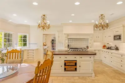 a kitchen with white cabinets and a table and chairs at @ Marbella Lane - Hidden Gem in Orange County in Orange