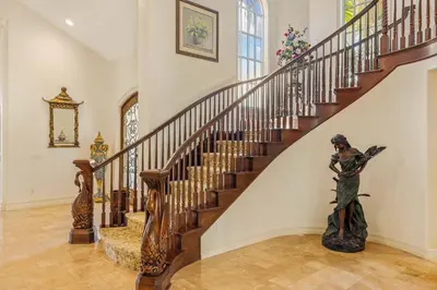 a staircase with a statue in the middle of a room at @ Marbella Lane - Hidden Gem in Orange County in Orange
