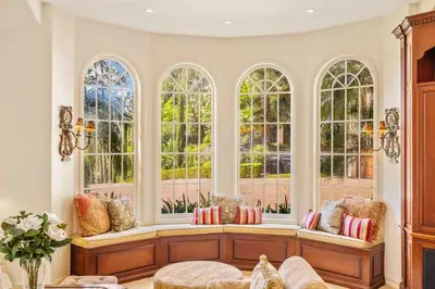 a living room with windows and a bench with pillows at @ Marbella Lane - Hidden Gem in Orange County in Orange
