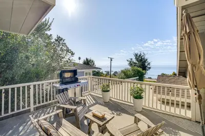 a patio with chairs and a grill on a balcony at Summerland Home with Beach Supplies Walk to Beach! in Summerland