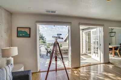 a camera on a tripod in a living room at Summerland Home with Beach Supplies Walk to Beach! in Summerland