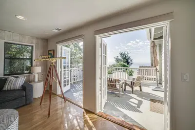 a living room with a view of the ocean at Summerland Home with Beach Supplies Walk to Beach! in Summerland