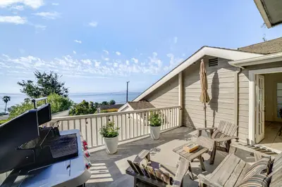 a porch with chairs and a car parked on it at Summerland Home with Beach Supplies Walk to Beach! in Summerland