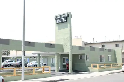 a building with a sign for a motel at Town House Motel in Lynwood