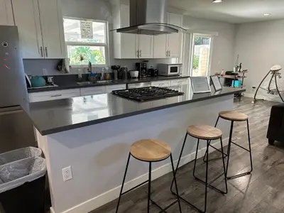 a kitchen with a counter and two stools at Cheers Hostel in Los Angeles