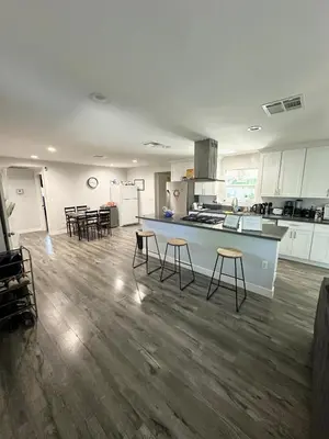 a large kitchen with a counter and stools at Cheers Hostel in Los Angeles