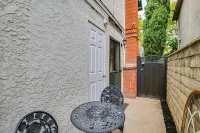 a table and two chairs in front of a door at Anaheim Studio with Fireplace 14 Mi to Disneyland! in Anaheim