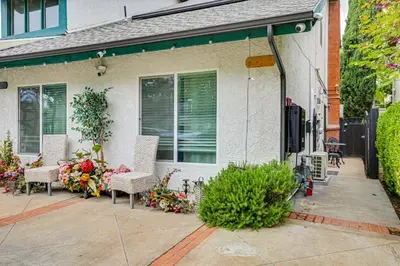 a house with chairs and flowers on a patio at Anaheim Studio with Fireplace 14 Mi to Disneyland! in Anaheim