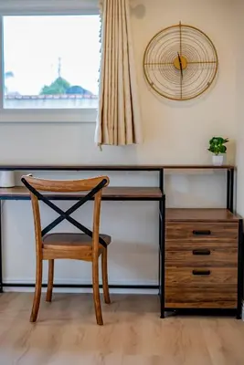 a desk with a chair and a clock on a wall at Peaceful Family Home with 3 Bedrooms and 2 Bathrooms in Glendora