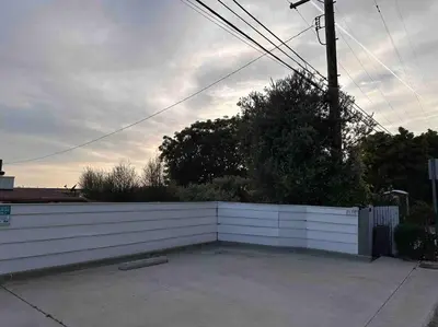 a white fence in a driveway next to a house at 30 PCT OFF!! Limited Time! Malibu Ocean Wave with King Bed, Walking to Beach and Hiking in Malibu