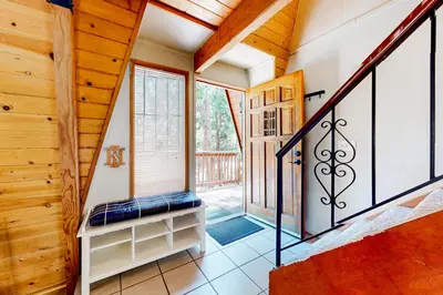 a staircase in a home with wooden walls at Hidden Wonder in Crestline