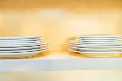 two stacks of plates sitting on a shelf at Newly Remodeled 3B2B House in Glendora