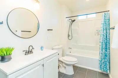 a bathroom with a sink and a toilet and a mirror at Newly Remodeled 3B2B House in Glendora