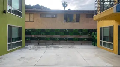 a bench sitting in the middle of a courtyard at Quintessence ApartHotel in Los Angeles