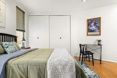 a bedroom with a bed and a table with a chair at Hollywood Hills Retreat w Sweeping Views 2 Bd 2 Bt in Los Angeles