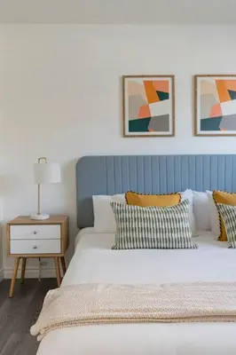 a bedroom with two beds and a table with a lamp at Enjoy Alhambra Night Life at 2BR Apt in Alhambra