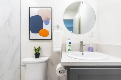 a bathroom with a sink and a toilet and a mirror at City Retreat Minutes to DT in Alhambra