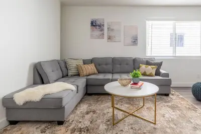 a living room with a couch and a table at City Retreat Minutes to DT in Alhambra