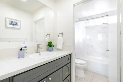 a white bathroom with a sink and a toilet at 4 bedroom Alhambra Condo near downtown LA in Alhambra