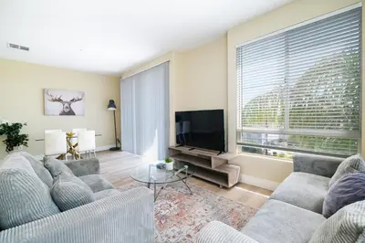 a living room with two couches and a flat screen tv at Vacation Apartments in Marina Del Rey in Los Angeles