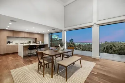 a kitchen and dining room with a table and chairs at Summitridge in Los Angeles