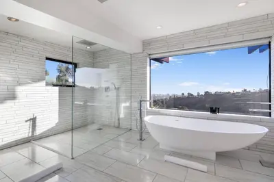 a bathroom with a tub and a large window at Summitridge in Los Angeles