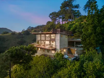 a house on top of a hill with trees at Summitridge in Los Angeles