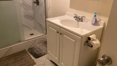 a white bathroom with a sink and a shower at Westminster Zen Home in Westminster