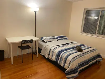 a bedroom with a bed and a desk and a chair at Westminster Zen Home in Westminster