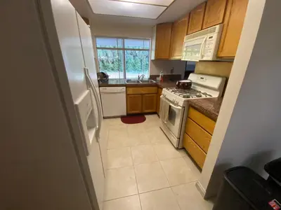 a kitchen with a white refrigerator and a stove at Westminster Zen Home in Westminster