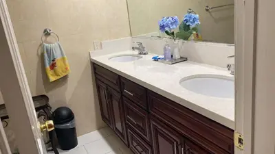 a bathroom with two sinks and a mirror at Westminster Zen Home in Westminster