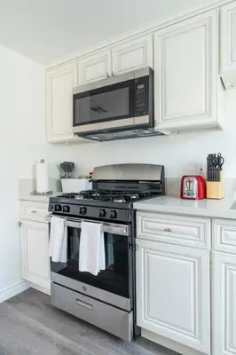 a kitchen with a stove and a microwave at Modern 2BR Condo with King Bed & Balcony near LA in Alhambra