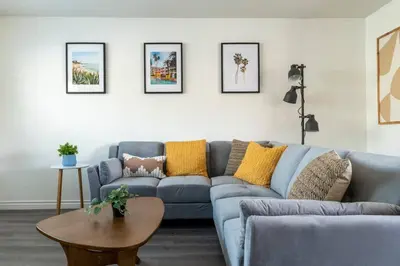 a living room with a blue couch and a table at Modern 2BR Condo with King Bed & Balcony near LA in Alhambra