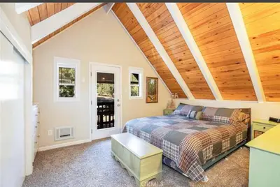 a bedroom with a bed and a wooden ceiling at Bernina Dr. Retreat in Pine Mountain Club