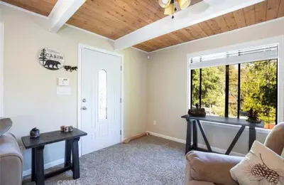 a living room with a couch and a table at Bernina Dr. Retreat in Pine Mountain Club